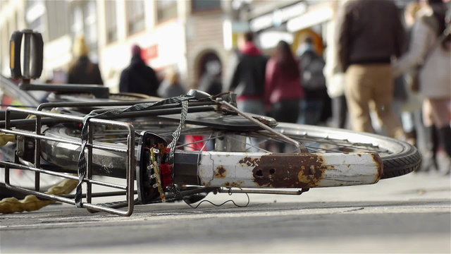 Fallen bike in a shopping district. A cityscape