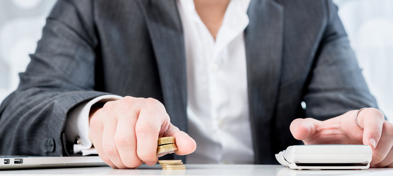 Successful accountant counting gold coins