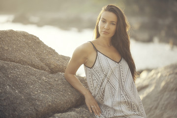 girl standing on the beach sea sunset rays