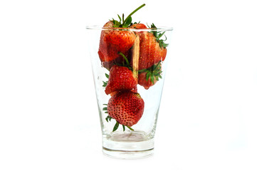 Fresh strawberry in a glass on a white background.