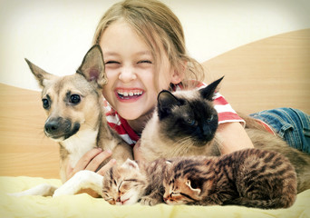 laughing child and a cat and a dog
