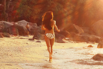 beautiful girl runs along the beach fitness holidays