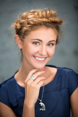 Fair-haired lovely girl with beautiful braided hair. Close portr