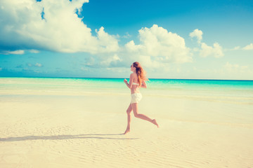Fototapeta na wymiar Woman running jogging during outdoor workout on beach