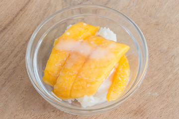mango with rice stick thai dessert on wood background