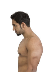 A young and fit male model posing his muscles