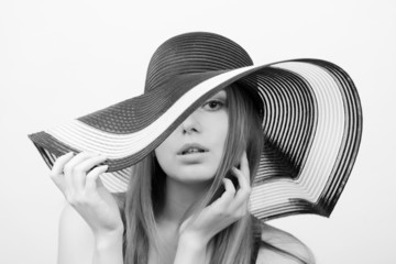 Beautiful girl in a hat on a white background.