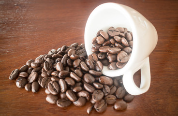 Roast coffee bean in white mug