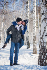Fototapeta na wymiar Couple walking in winter forest