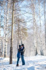 Couple walking in winter forest