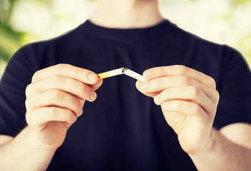 man breaking the cigarette with hands