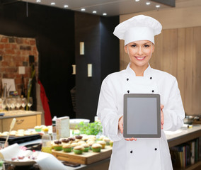 smiling female chef with tablet pc blank screen