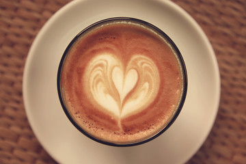 Coffee latte art on Tablecloth texture background - Vintage effe