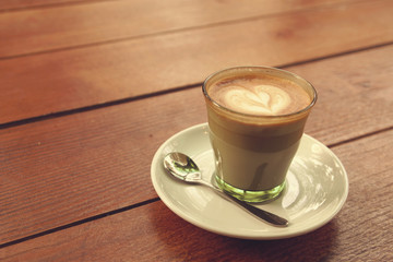 Coffee latte art on the wood texture background - Vintage effect