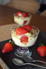 Vanilla pudding with fresh strawberries on the plate