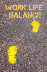 Yellow footsteps on sidewalk towards Work Life Balance message