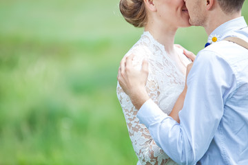 happy bride and groom on the green field