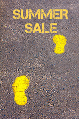 Yellow footsteps on sidewalk towards Summer Sale message