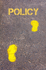 Yellow footsteps on sidewalk.Policy message.Concept image