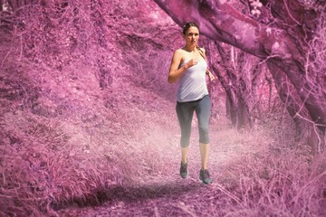 Obraz premium Composite image of focused fit blonde jogging