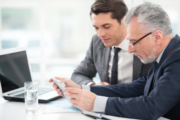 Two businessmen working with tablet computer