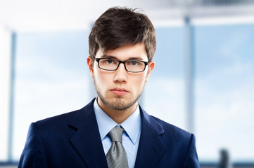 Handsome businessman against blurry background