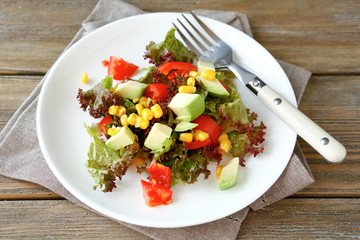 nutritious salad with avocado, tomatoes and corn