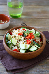 Tasty pearl barley salad with fresh vegetables in a bowl