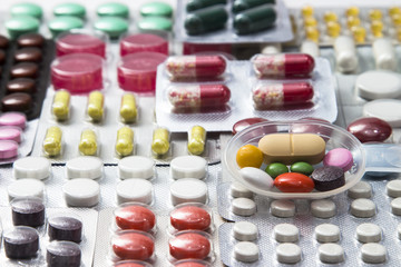 background of tablets, capsules and vitamins in blisters