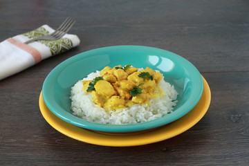 Chicken curry with rice on wooden table