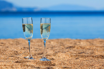 Wine glasses on a beach