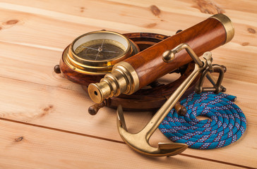 maritime adventure old anchor and wooden steering wheel