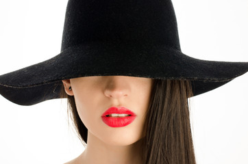 Woman with a big black hat covering her eyes,perfect red lips