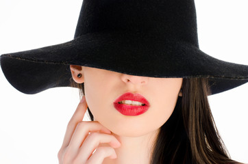 Woman with a big black hat covering her eyes,perfect red lips