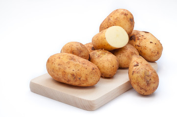 Potatoes on wooden board
