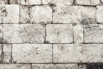 Old wall made of dark gray stones, texture
