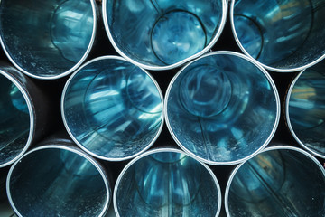 Empty blue shining metal tubes with perspective
