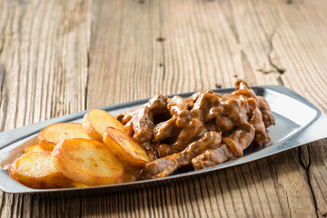 Beef Stroganoff, strips of beef in sour cream served with crisp