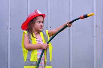 Fototapeta premium Child girl in fireman costume