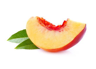 Slice of peach with leaf isolated.