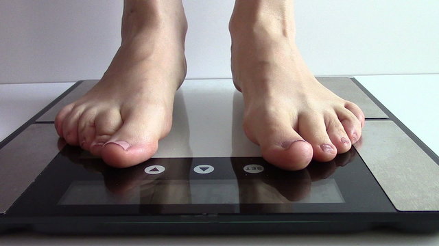 woman rises on a digital scale
