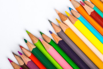 Several color pencils on a white paper sheet