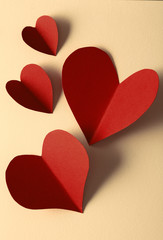 Beautiful paper hearts on paper background, close-up
