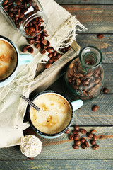 Beautiful composition with tasty cappuccino on wooden table