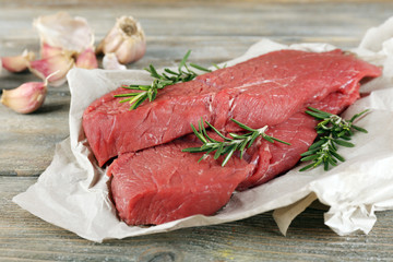 Raw beef steak with rosemary and garlic