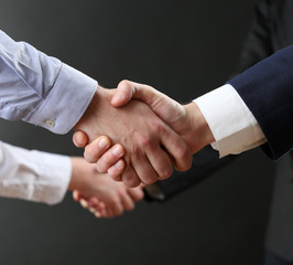 Business handshake on dark background