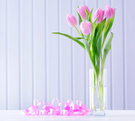 Beautiful pink tulips in vase with decorative hearts