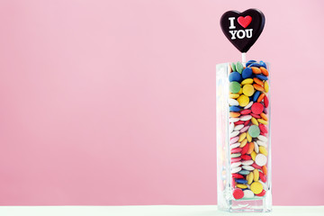 Colorful sweets with inscription in vase