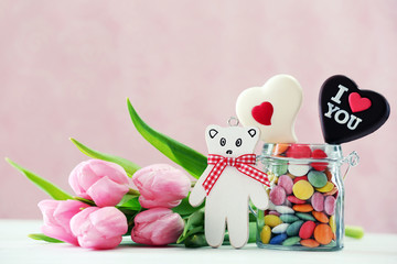 Beautiful pink tulips with jar of sweets