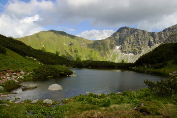 Fototapeta na wymiar Mountain Lake Surrounded by Hills